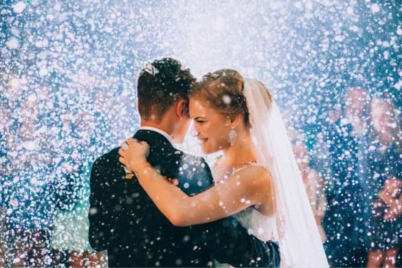 bride and groom sharing their first dance with confetti in the air